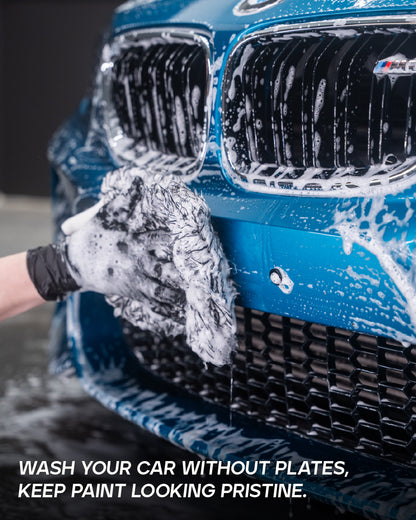 Washing a blue BMW M bumper with the license plate removed using QuickPlate magnetic holder