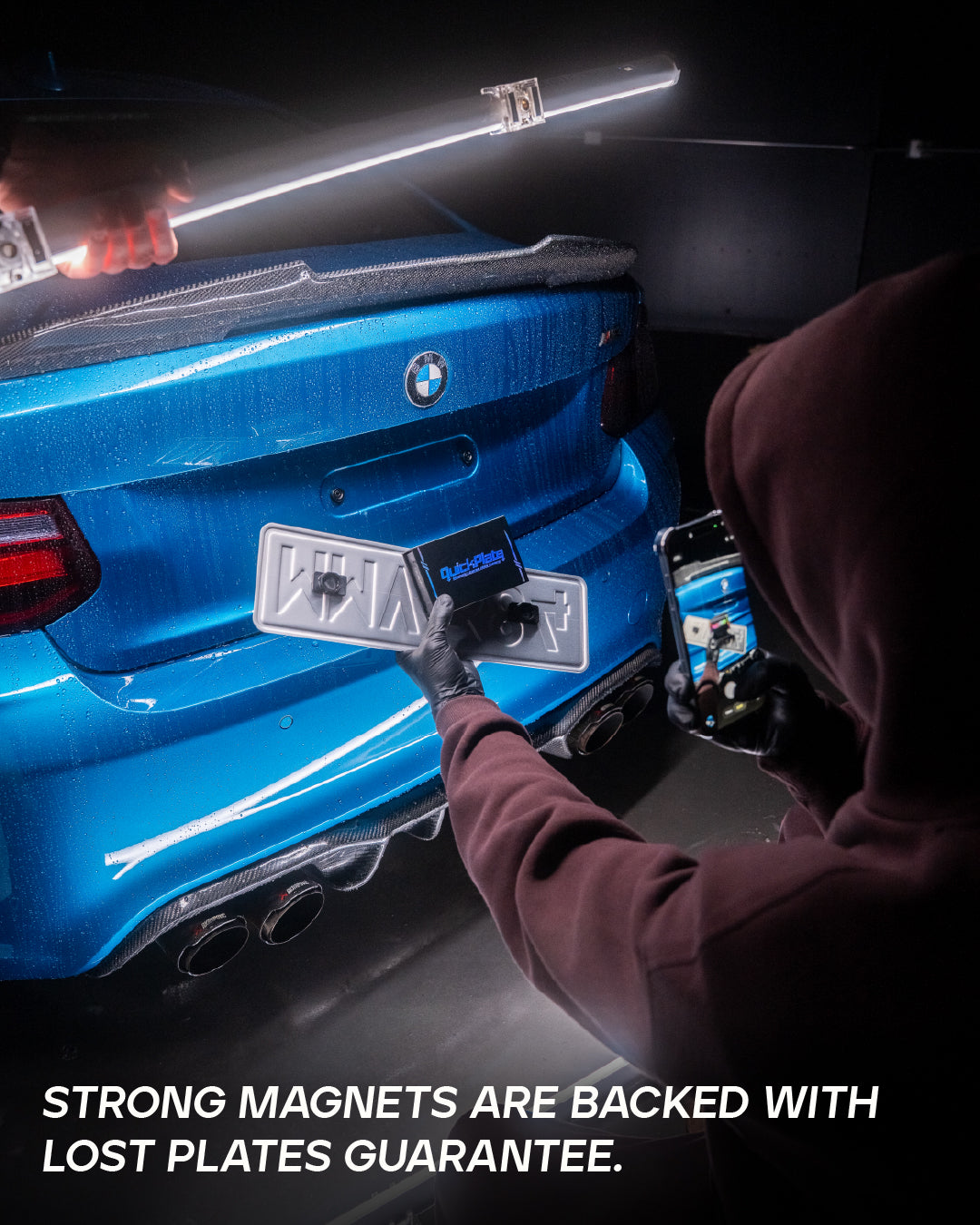 Installing QuickPlate magnetic license plate holder on blue BMW rear bumper